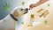 A dog is being given CBD oil, surrounded by cannabis leaves, CBD oil and CBD treats